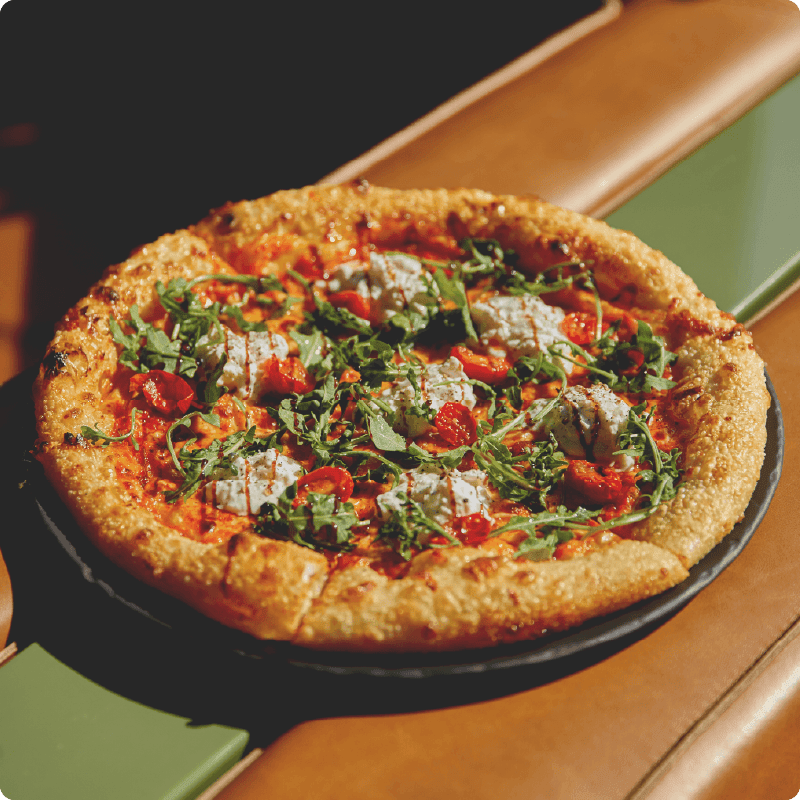 King Taps Hella Stracciatella Pizza, with Stracciatella, arugula, Grana Padano, balsamic glaze.