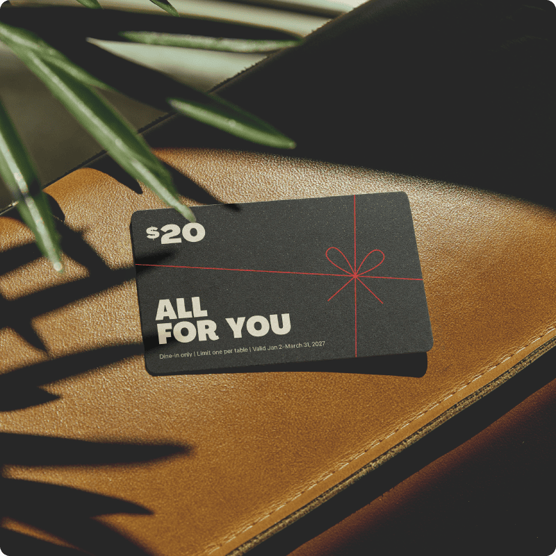 $20 bonus gift card on top of a leather surface